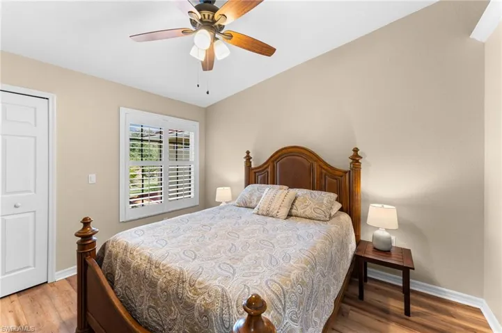 Bedroom featuring a closet, hardwood / wood-style floors, and ceiling fan