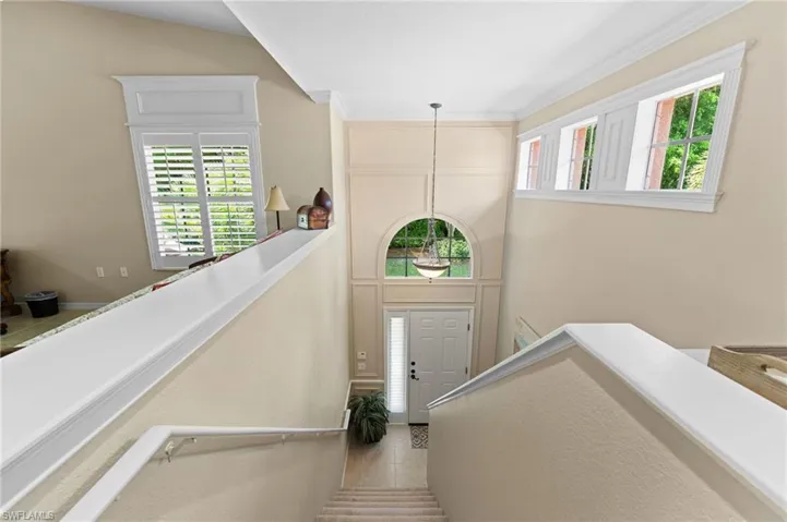 Stairs featuring light tile patterned floors and plenty of natural light