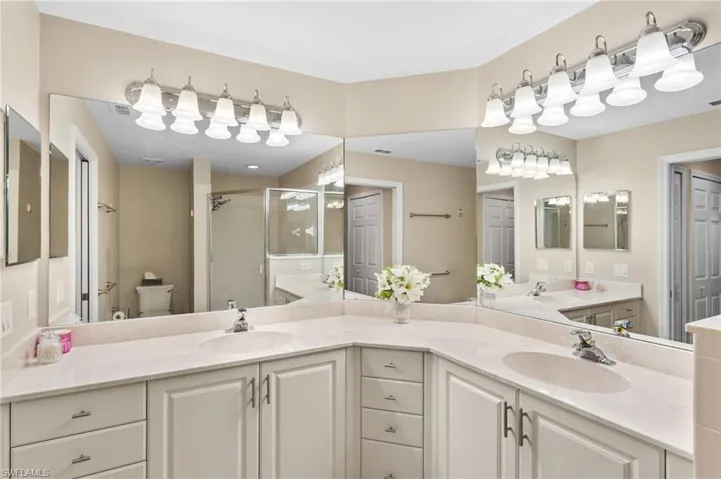 Bathroom featuring toilet and double sink vanity
