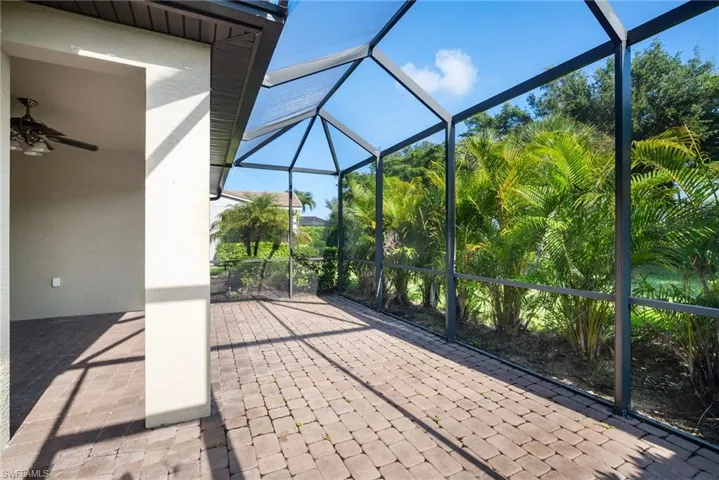 Unfurnished sunroom featuring ceiling fan