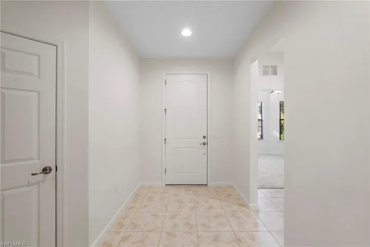 Corridor with light tile patterned floors
