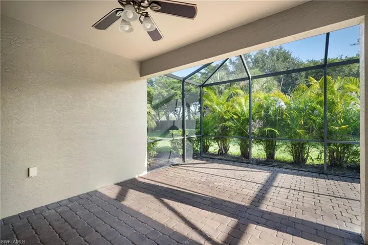 Unfurnished sunroom featuring ceiling fan