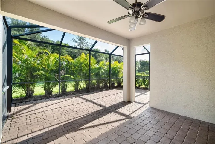 Unfurnished sunroom featuring ceiling fan