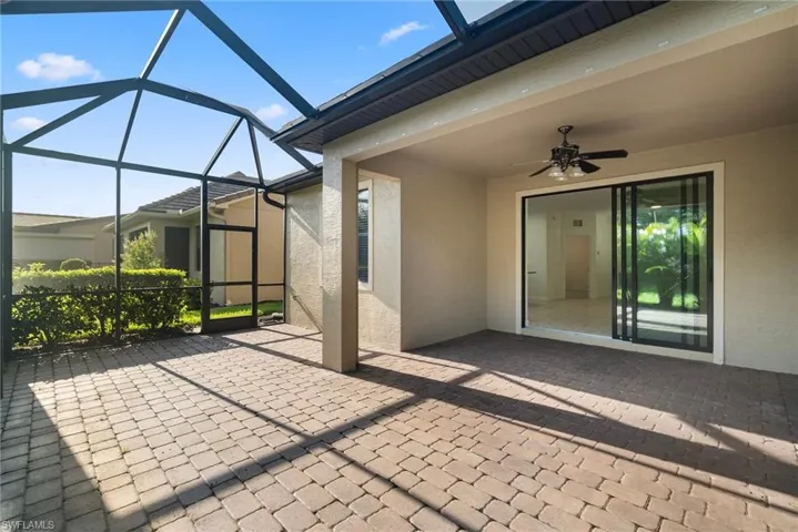 Unfurnished sunroom with ceiling fan