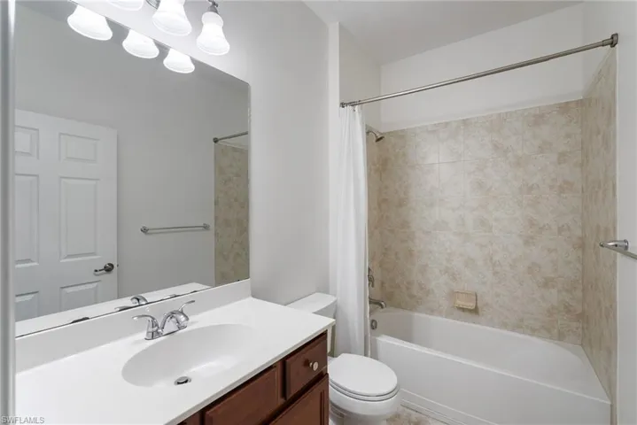 Full bathroom with shower / tub combo, vanity, and toilet