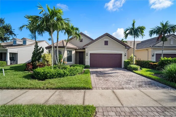 Ranch-style house with a garage and a front yard