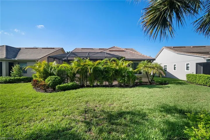 Back of house featuring a lawn