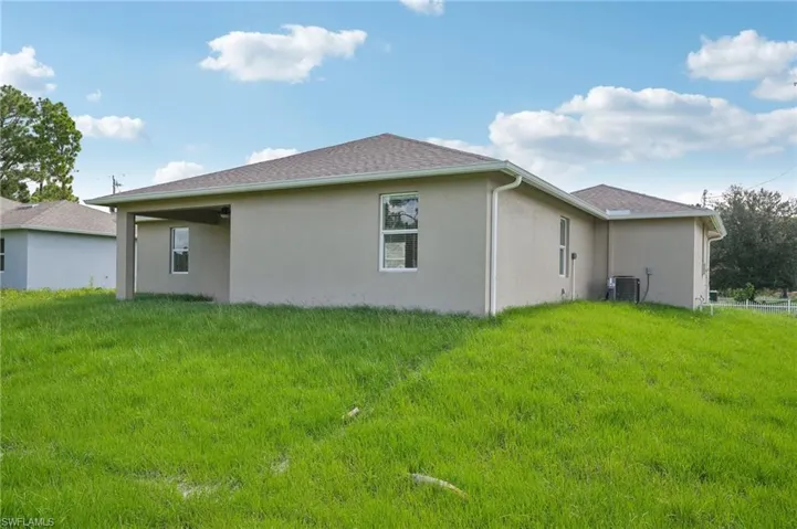 View of home's exterior with a yard and central air condition unit