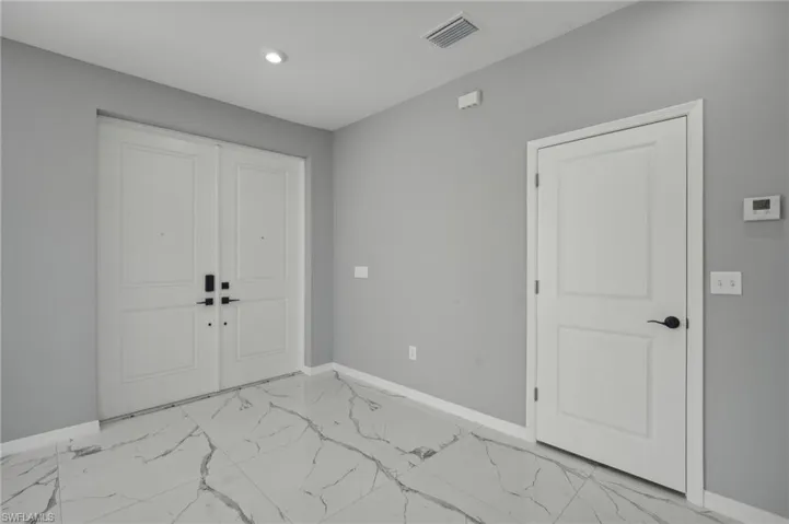 Entryway with light tile patterned flooring