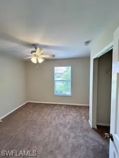Unfurnished bedroom featuring baseboards, carpet flooring, ceiling fan, and a closet
