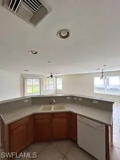 Kitchen featuring visible vents, a healthy amount of sunlight, a sink, and dishwasher