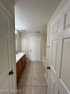 Bathroom with walk in shower, a sink, double vanity, toilet, and visible vents