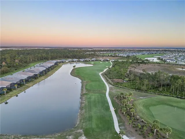 Aerial view at dusk featuring a water view