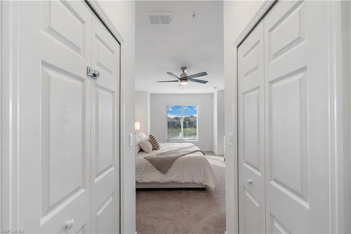 Bedroom featuring light colored carpet and ceiling fan