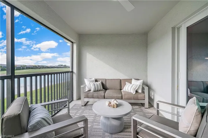 Sunroom featuring a water view