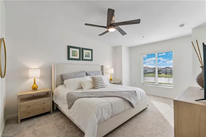 Carpeted bedroom with ceiling fan