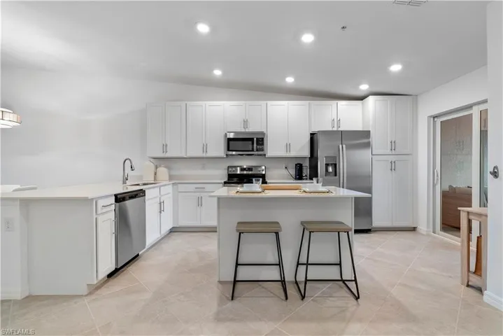 Kitchen with white cabinets, stainless steel appliances, and sink