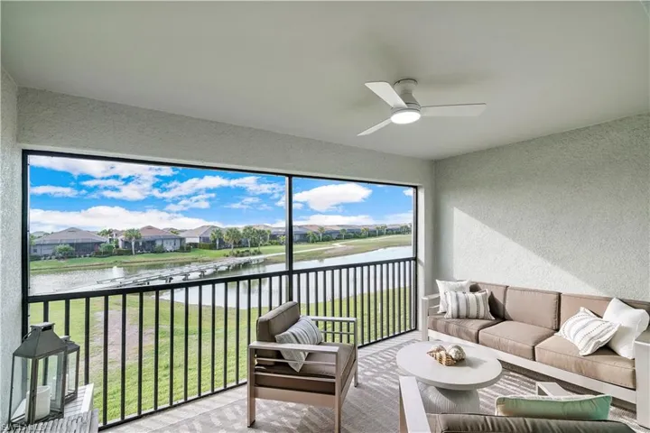 Sunroom with a water view and ceiling fan