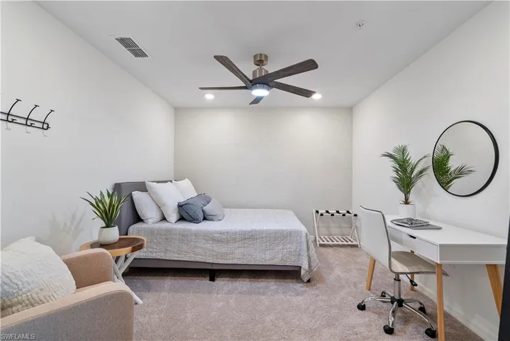 Carpeted bedroom with ceiling fan