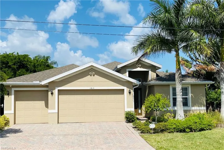 Ranch-style house with stucco siding, driveway, a garage, and roof with shingles
