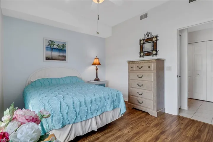 Bedroom with vinyl floors and ceiling fan