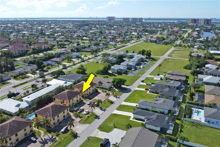 Aerial view of the condo the building and surrounding homes