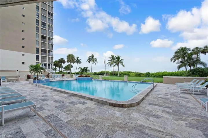 Community pool with a patio