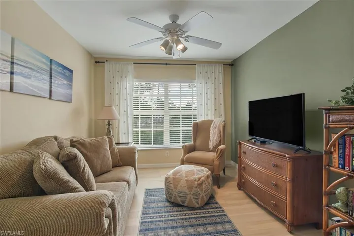 Living room featuring wood finished floors and ceiling fan