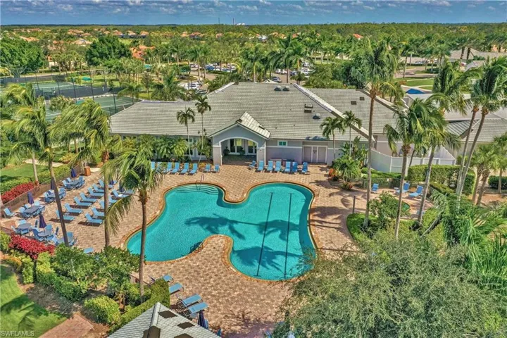 Bird's eye view of a pool area and a tree filled landscape