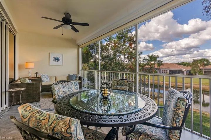 Sunroom / solarium with a ceiling fan, an outdoor living space, a water view, and a balcony
