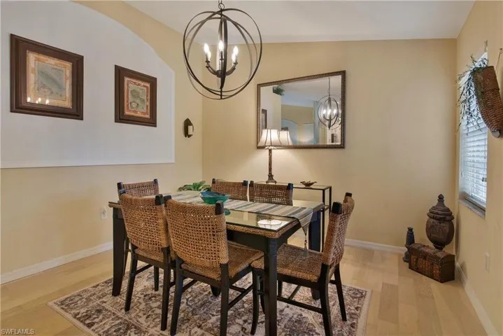 Dining area featuring a chandelier and light wood-type flooring