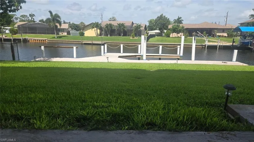 View of community with a lawn and a water view