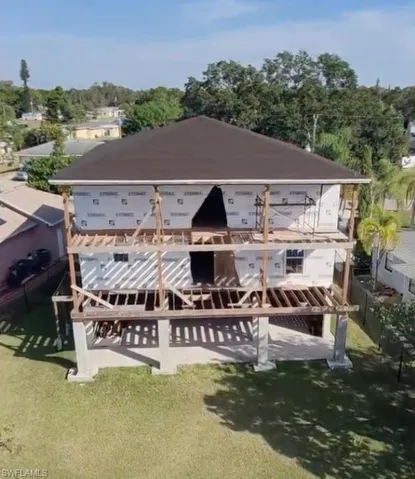Rear view of property featuring a yard