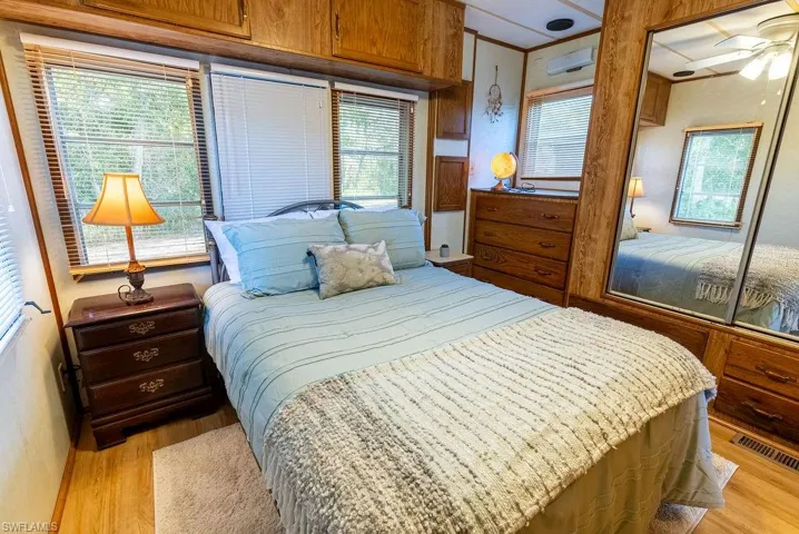 Bedroom featuring a closet, light wood-style flooring, and a ceiling fan