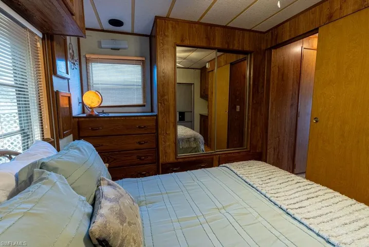 Bedroom with a closet and wood walls