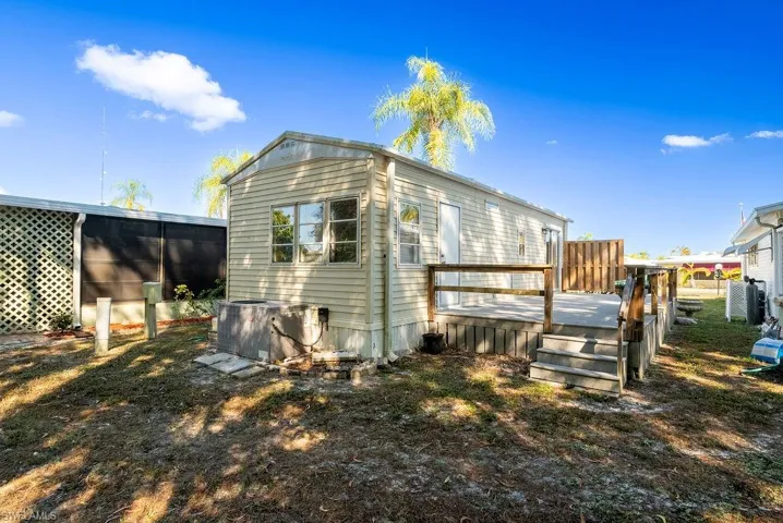 Back of property featuring a wooden deck