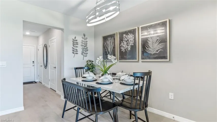 Dining area featuring wood-type flooring and a notable chandelier