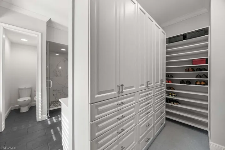 Walk in closet featuring dark tile patterned floors