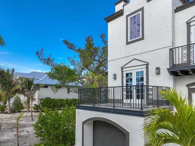 Back of property featuring french doors and a balcony
