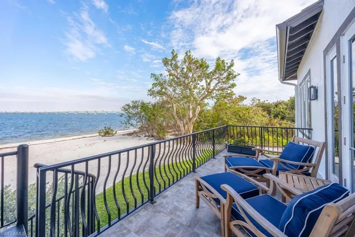 Balcony with a view of the beach and a water view
