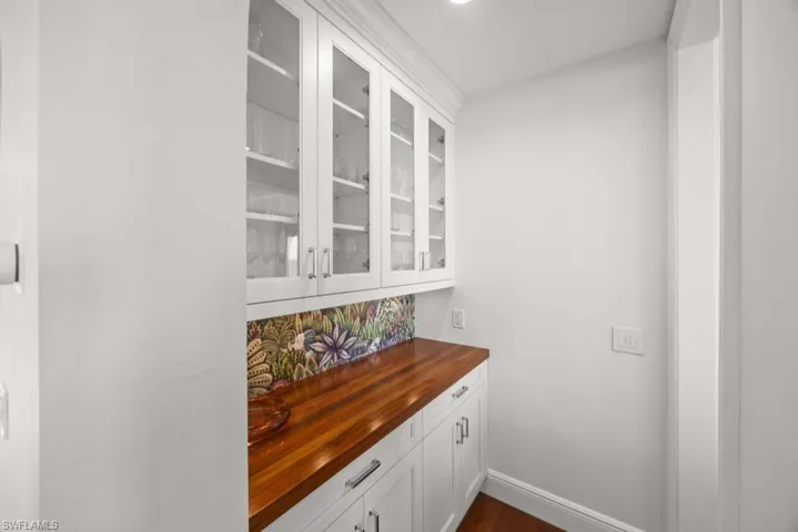 Bar featuring white cabinetry