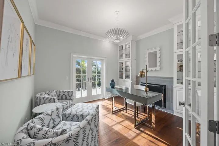 Office area with french doors, ornamental molding, and hardwood / wood-style floors
