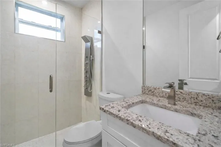 Bathroom featuring vanity and a shower stall