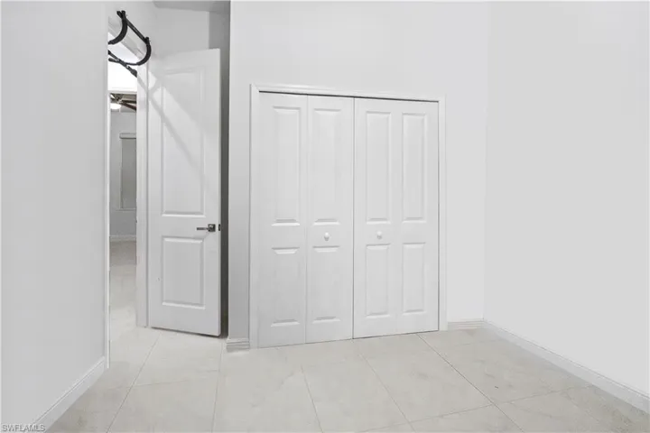 Unfurnished bedroom with baseboards and a closet