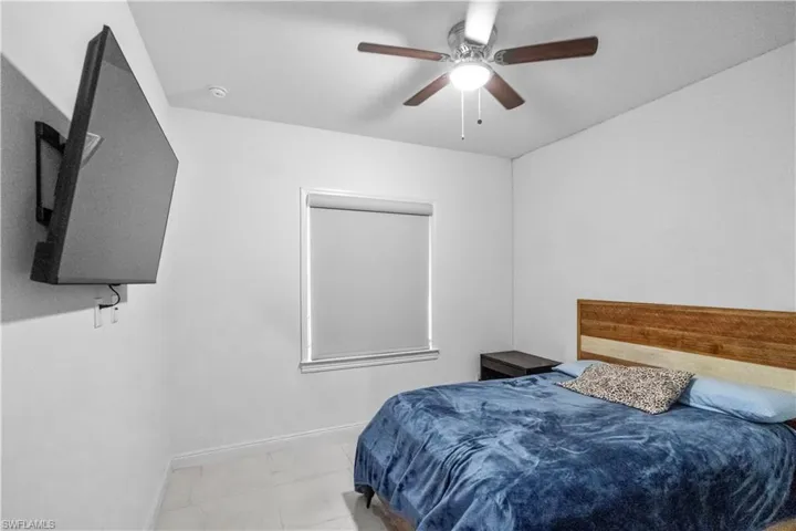 Bedroom featuring a ceiling fan and baseboards