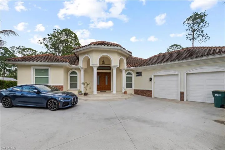 Mediterranean / spanish-style house featuring driveway, stucco siding, a garage, and a tiled roof