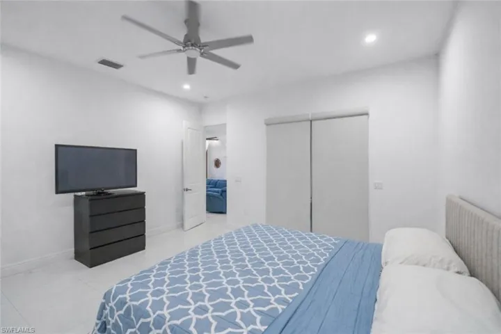 Bedroom featuring a ceiling fan, recessed lighting, and a closet