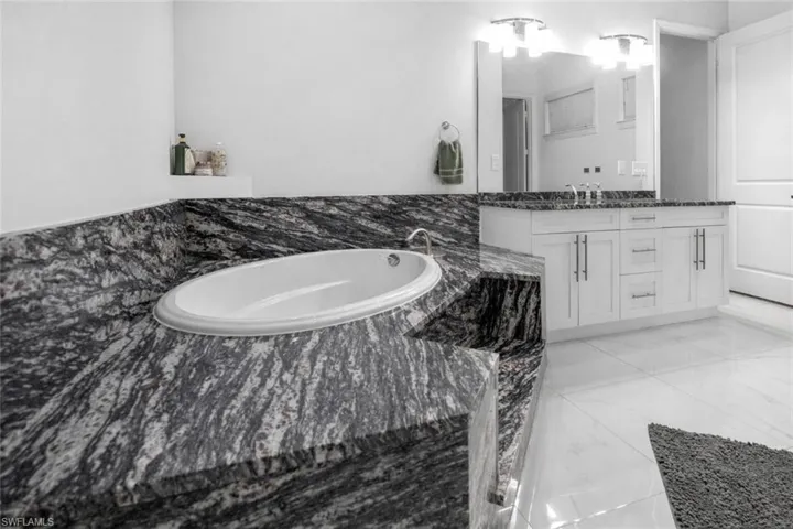 Bathroom featuring vanity and a bath