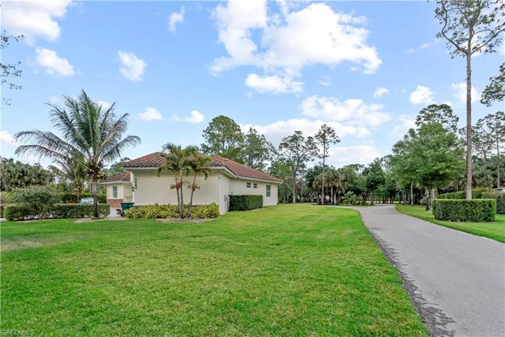 View of property exterior featuring a yard and stucco siding