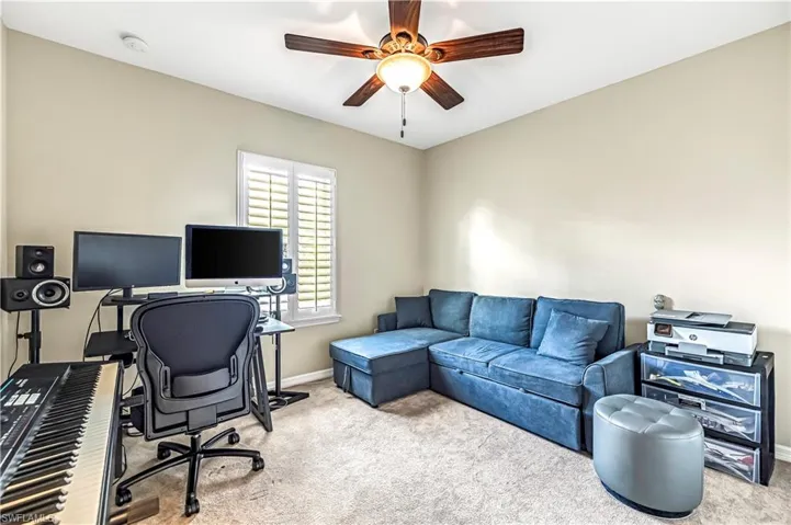 Office space with carpet floors and a ceiling fan
